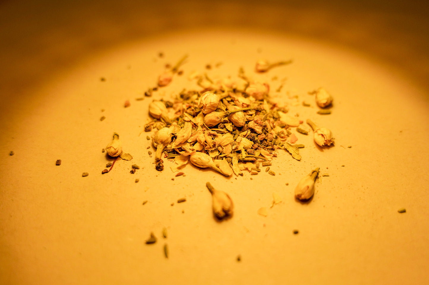 Tru Essence's Saffron Serenity herbal blend laid out on a surface. On display are saffron, cinnamon, cardamon, clove, black pepper, ginger, fennel, and jasmine buds.